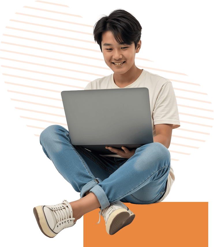 smiling boy using laptop crosslegged